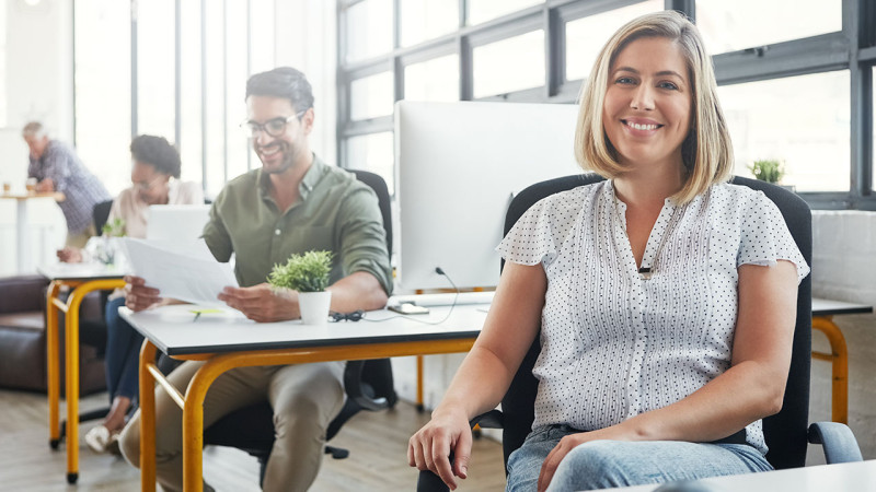 Modern office with coworkers smiling