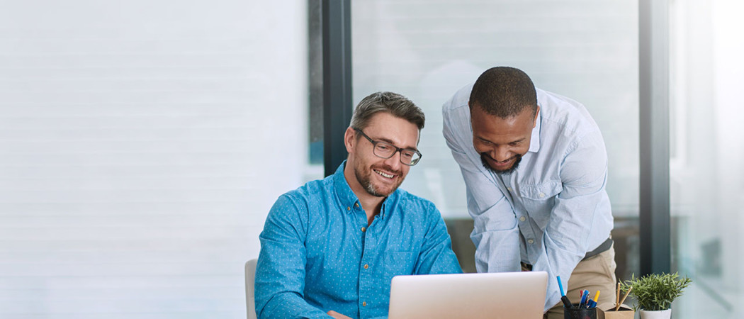 Employees working together on a laptop